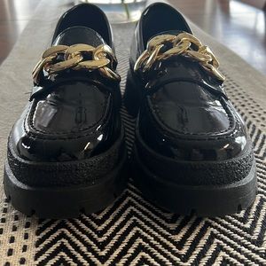 Shiny black loafers with a chunky low platform